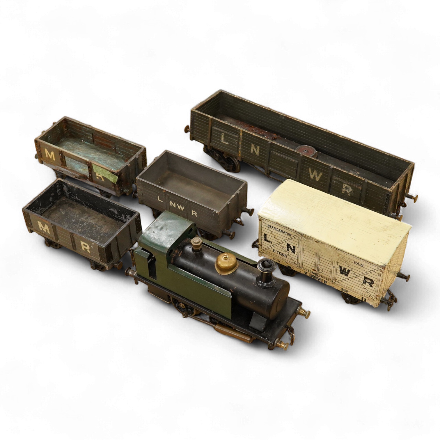 A Gauge One live steam 0-4-0T locomotive in the style of a Bowman model locomotive, with spirit fired with two simple outside oscillating cylinders, together with five LNWR and Midland Railway freight wagons, including a